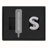 Moleskine Pins S Silver: Stylish Zinc Alloy pins for personalizing notebooks with letters or initials on the elastic closure.