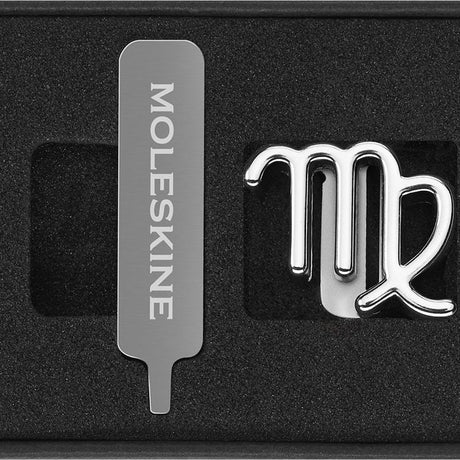 Moleskine Pins Virgo Silver showcases a sleek silver zodiac pin, perfect for personalizing notebooks and planners.