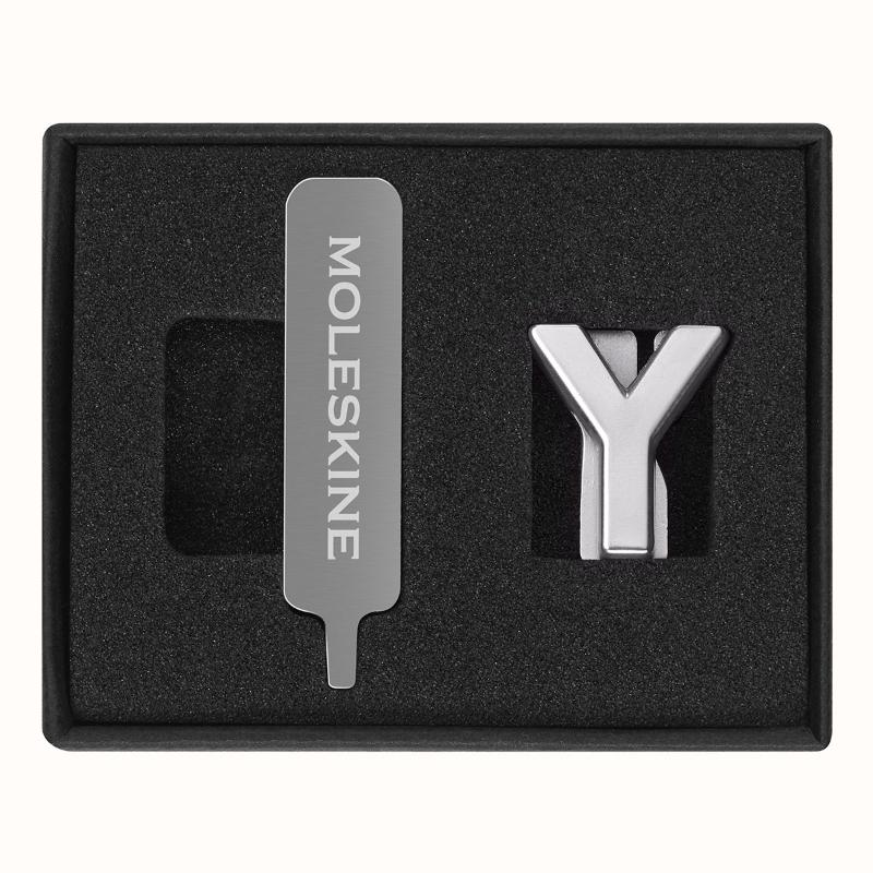 Stylish Moleskine Pins Y Silver for personalizing notebooks with customizable letters on the elastic closure.