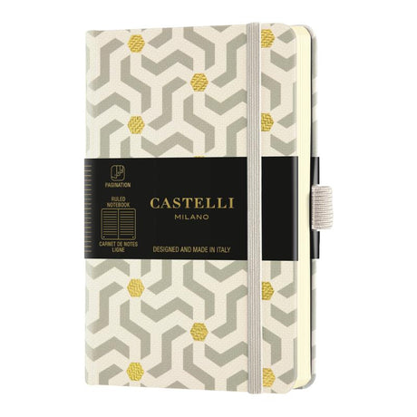 Castelli Notebook Oro with geometric design, ivory ruled pages, gold marker, and eco-friendly certification.