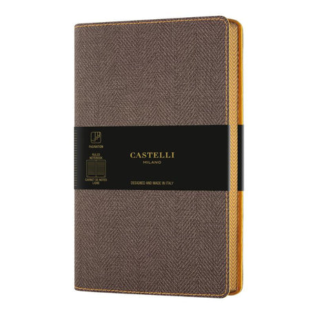 Castelli Harris Pocket Ruled Notebook in Tobacco Brown, featuring a tweed cover, ivory pages, and ribbon marker for elegant note-taking.