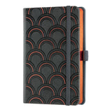 Luxurious Art Deco copper notebook with embossed cover, ruled ivory pages, ribbon marker, and eco-friendly certification.