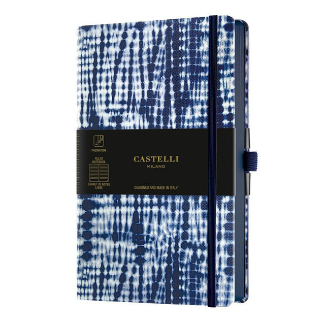 A5 ruled notebook with Shibori blue patterns, ivory pages, blue edges, ribbon marker, and eco-friendly materials.