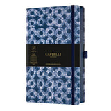 A5 notebook featuring blue Shibori patterns, ruled ivory pages, blue edges, ribbon marker, and eco-friendly design.