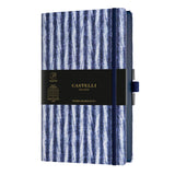 Elegant A5 notebook with blue Shibori patterns, ruled ivory pages, ribbon marker, and eco-friendly design from Italy.