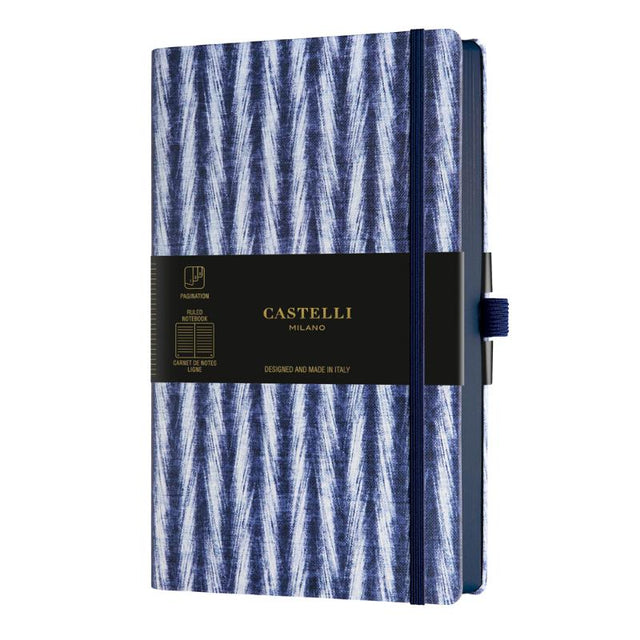 Elegant A5 notebook with blue Shibori patterns, ruled ivory pages, ribbon marker, and eco-friendly design from Italy.