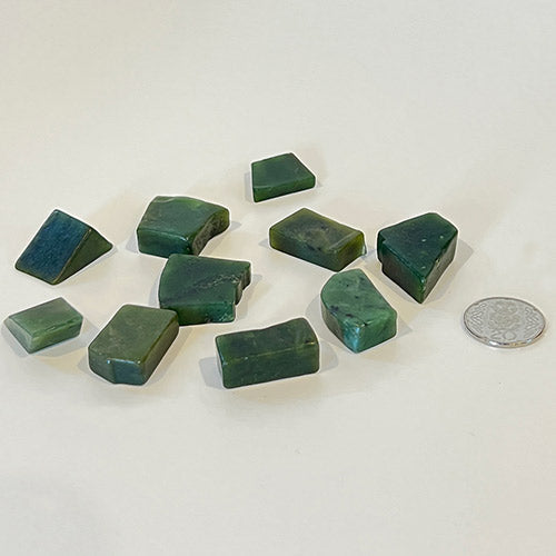 Jade tumbled offcuts in a bag, showcasing green hues, smooth polish, ideal for collectors and spiritual connection.