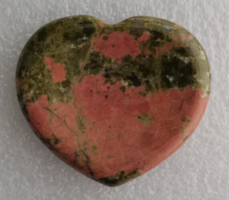 Unakite Heart worry stone (4cm) in hand, promoting calmness and emotional healing for stress relief and mindfulness.