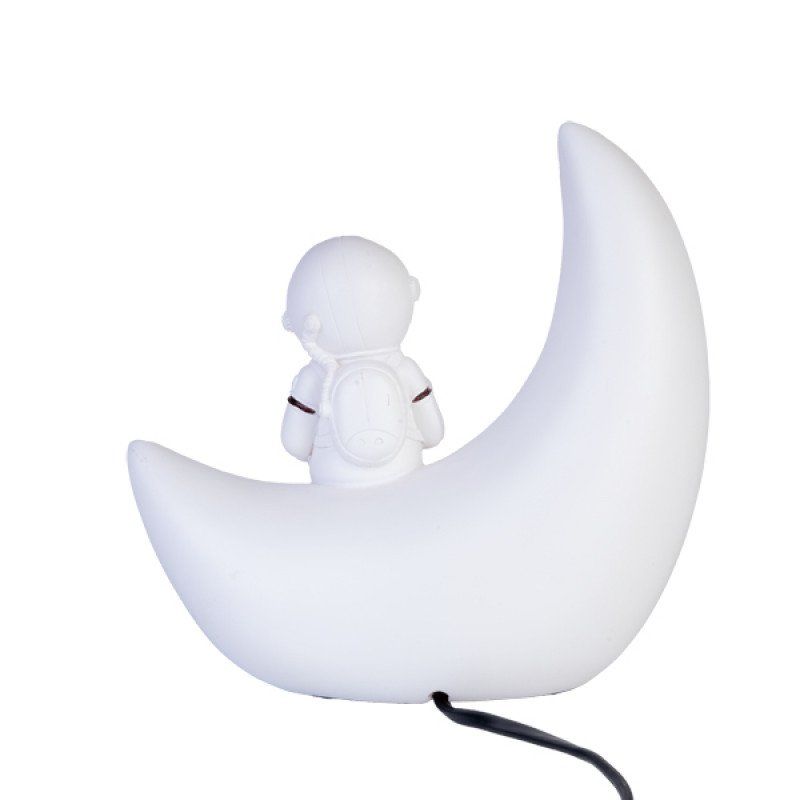 Moon Astronaut Table Lamp featuring an astronaut on a crescent moon, providing a warm glow for children's rooms.