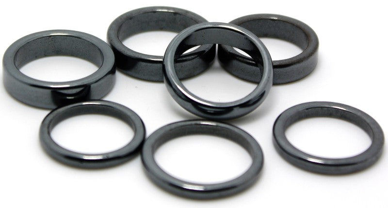 A collection of 100 mixed-size Mini Hematite Rings showcasing a metallic sheen, ideal for jewelry making and holistic wellness.