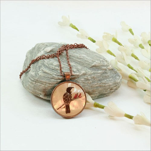 Circle Pendant Necklace featuring a filigree tui design on mother of pearl, with a 30mm pendant and 75cm adjustable chain.