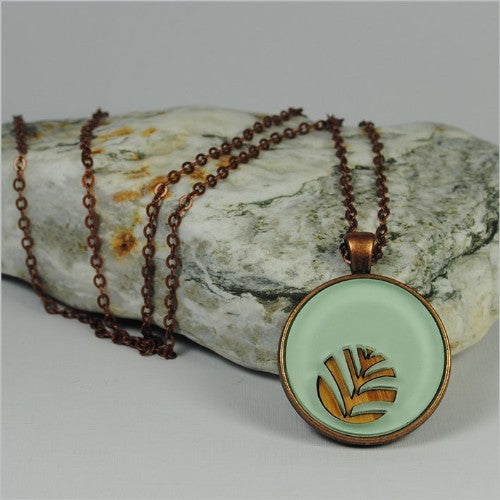 Palm green circle pendant necklace made from bamboo veneer and acrylic, featuring a 30mm pendant on a 75cm chain.