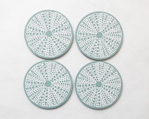 Set of 4 elegant printed coasters featuring Kina-inspired art, designed to protect surfaces while enhancing home decor.