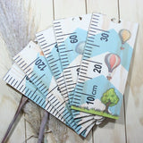 Whimsical space-themed growth chart ruler for tracking children's height, perfect for nurseries and playrooms.