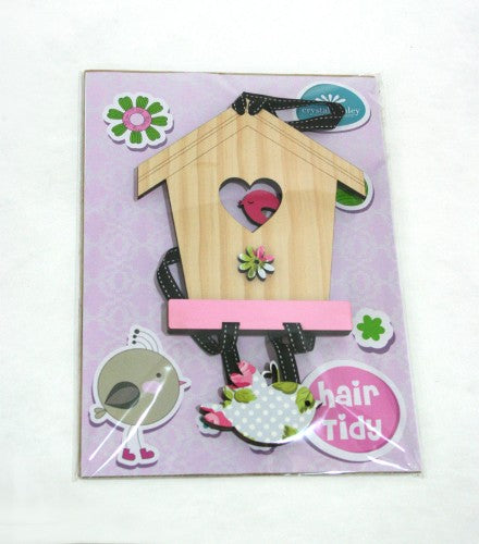 Charming hair accessory organizer in pink and wood, featuring a birdhouse design for effortless tidiness and decor.