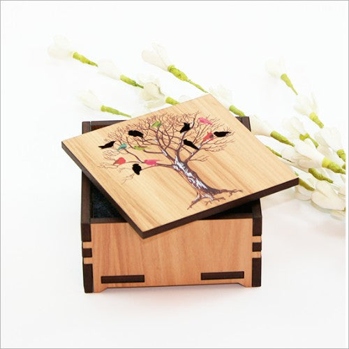 Wooden trinket box with paua inlay, featuring birds on a tree design, perfect for storing small treasures.