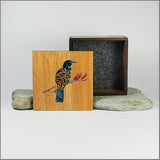 Small trinket box in NZ Silver Beech with filigree tui design and vibrant paua inlay, perfect for storing keepsakes.