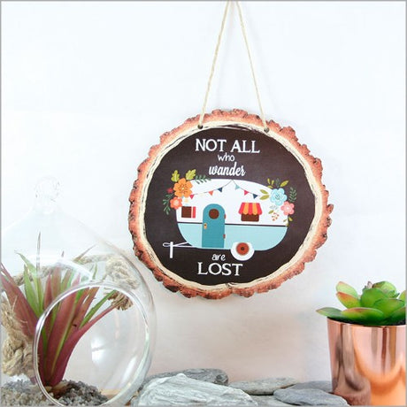 Rustic wood slice wall art featuring a caravan design, perfect for adding warmth and adventure to any space.