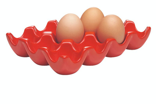 Vibrant red stoneware egg tray holding a dozen eggs, perfect for stylish storage and serving in any kitchen.