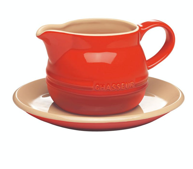 Red stoneware gravy boat with saucer, 450ml capacity, elegant design for serving sauces, microwave and dishwasher safe.