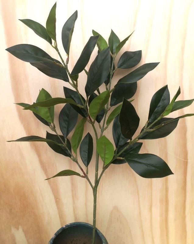 Lifelike Artificial Mandarin Leaf Spray adding vibrant greenery to home or office decor, perfect for any theme.