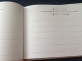 Elegant Christening Day Guest Book with padded hard cover, customizable metal plaque, and space for heartfelt messages.