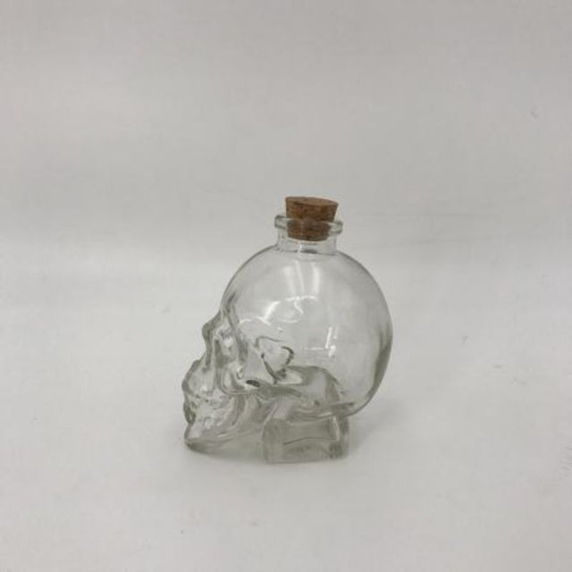 Set of 12 skull-shaped glass bottles for drinks, oils, or creative storage, perfect for parties and Halloween decor.