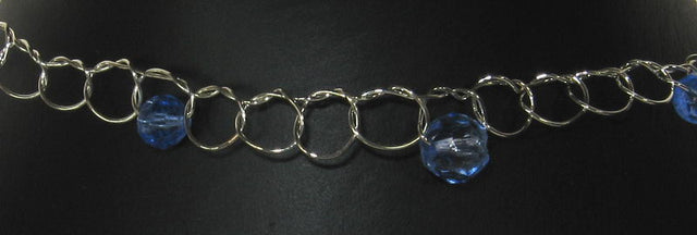 Elegant choker necklace with silver loops and a vibrant sapphire gemstone, perfect for any occasion.