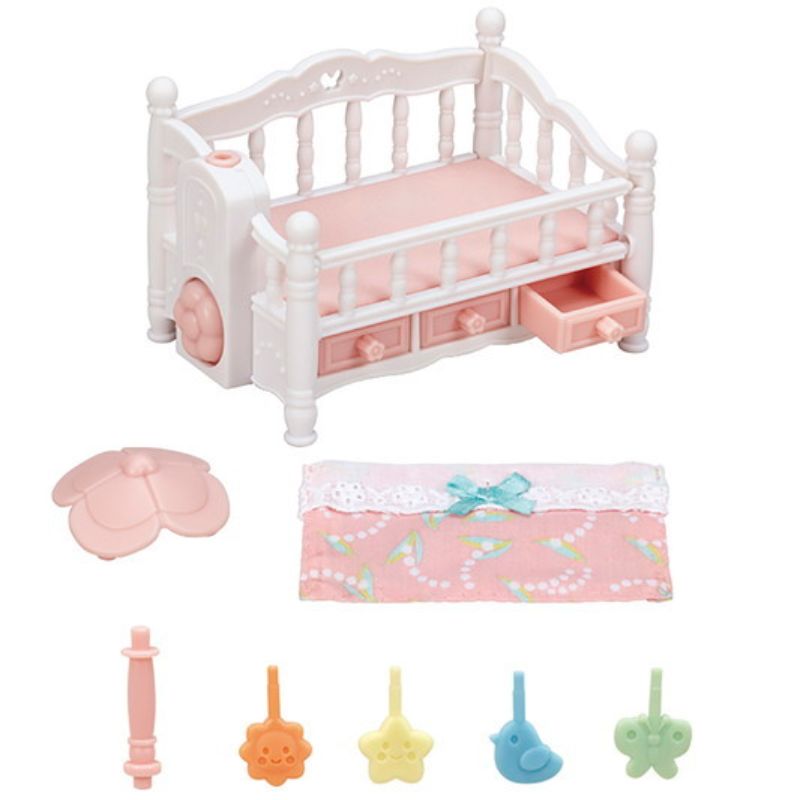 Enchanting crib for triplet babies with a spinning mobile, featuring whimsical decorations and three storage drawers.