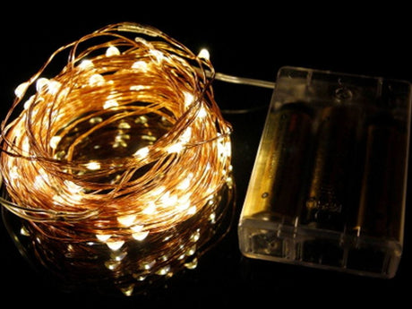 Warm white LED seed lights on flexible copper wire, 5M long with 50 bulbs, ideal for cozy indoor decorations.