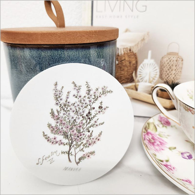 Vibrant acrylic coaster featuring Sarah Featon's watercolour illustration of the Manuka flower, 10cm with cork base.