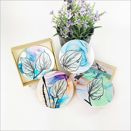 Coasters set featuring Kawakawa leaf designs on acrylic with cork base, elegantly protecting surfaces in style.