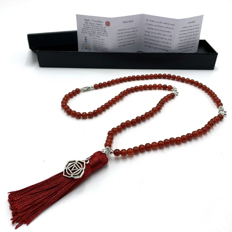 Mala beads necklace featuring vibrant carnelian stones and a Root Chakra charm, perfect for meditation and spiritual healing.