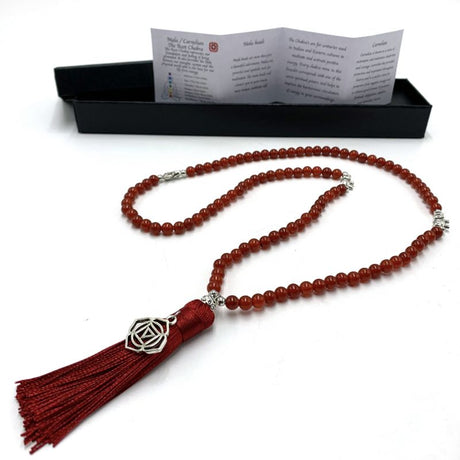Mala beads necklace featuring vibrant carnelian stones and a Root Chakra charm, perfect for meditation and spiritual healing.