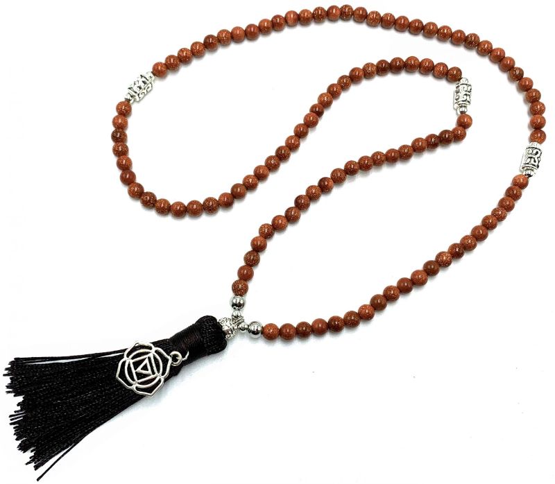 Mala beads made of goldstone with a root chakra charm, ideal for meditation, mindfulness, and stylish everyday wear.