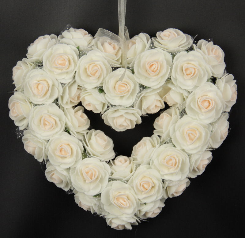 Heart-shaped medium pink rose wreath, 19x21 inches, adds elegance and warmth to any space or occasion.
