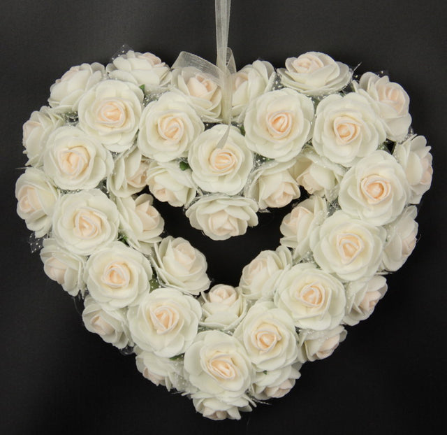 Heart-shaped medium pink rose wreath, 19x21 inches, adds elegance and warmth to any space or occasion.