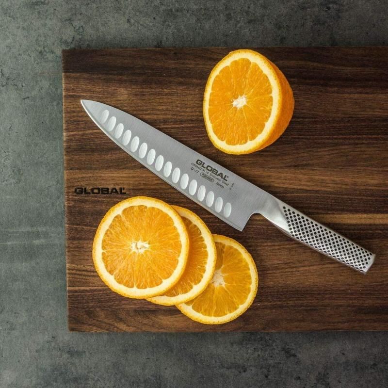 Global G-77 20cm fluted cooks knife in stainless steel, designed for precision, safety, and effortless food preparation.