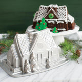 Nordic Ware Gingerbread House Bundt Pan for festive baking, featuring a 9-cup capacity and durable cast aluminum design.