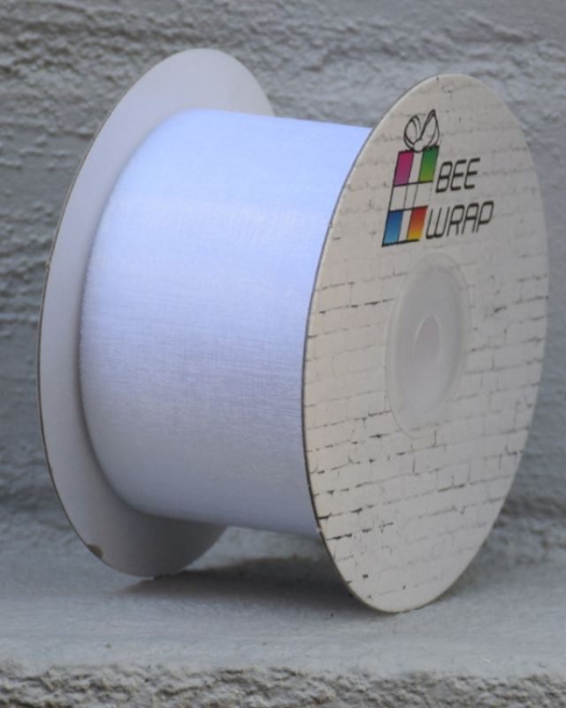 White 50mm cut edge organza ribbon on a 50m roll, perfect for elegant decorations and gift wrapping projects.
