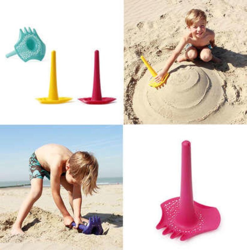 Bright yellow Triplet shovel/rake set by Quut, perfect for kids to dig, sift, and build at the beach or sandbox.