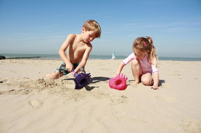 Bright blue multifunctional Triplet Shovel/Rake set for beach play, featuring a shovel, sand sifter, and rake.