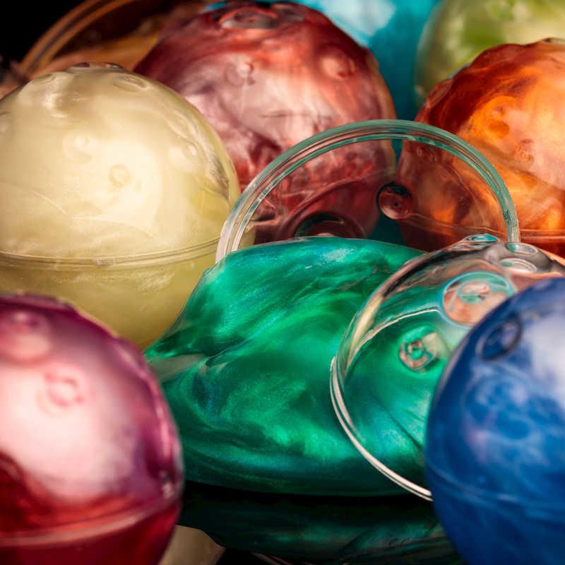 Colorful squishy putty planets in a kit, designed for kids to explore and learn about the solar system creatively.