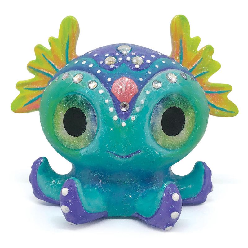 Colorful figurine painting kit featuring two fantasy creatures, paint, brushes, rhinestones, and glitter for creative fun.