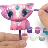 Two figurine painting kits featuring colorful acrylics, brushes, and accessories for creating enchanting fantasy creatures.