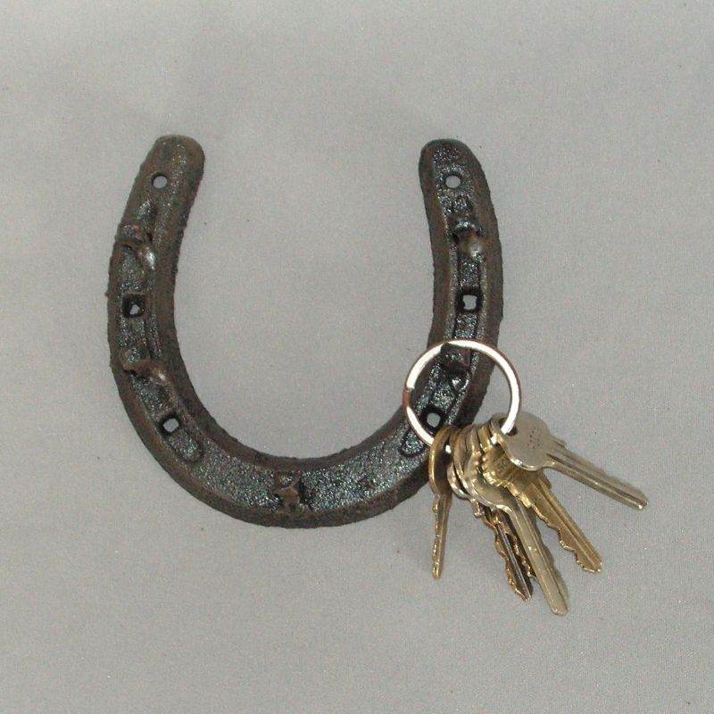 Horse shoe key rack with 5 hooks, perfect for equestrian decor and keeping keys and essentials organized.