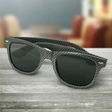 A set of 30 Malibu Premium Sunglasses in carbon fibre grey, featuring UV400 lenses and impact-resistant frames.