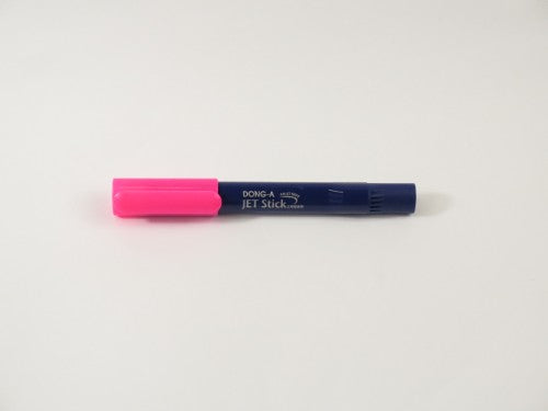 Dong-A Jet Stick Highlighter in vibrant pink, featuring a fine tip and transparent design for ink level monitoring.