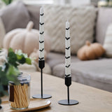 Eerie dinner candles adorned with 3D bats, perfect for creating a spooky ambiance at Halloween gatherings.