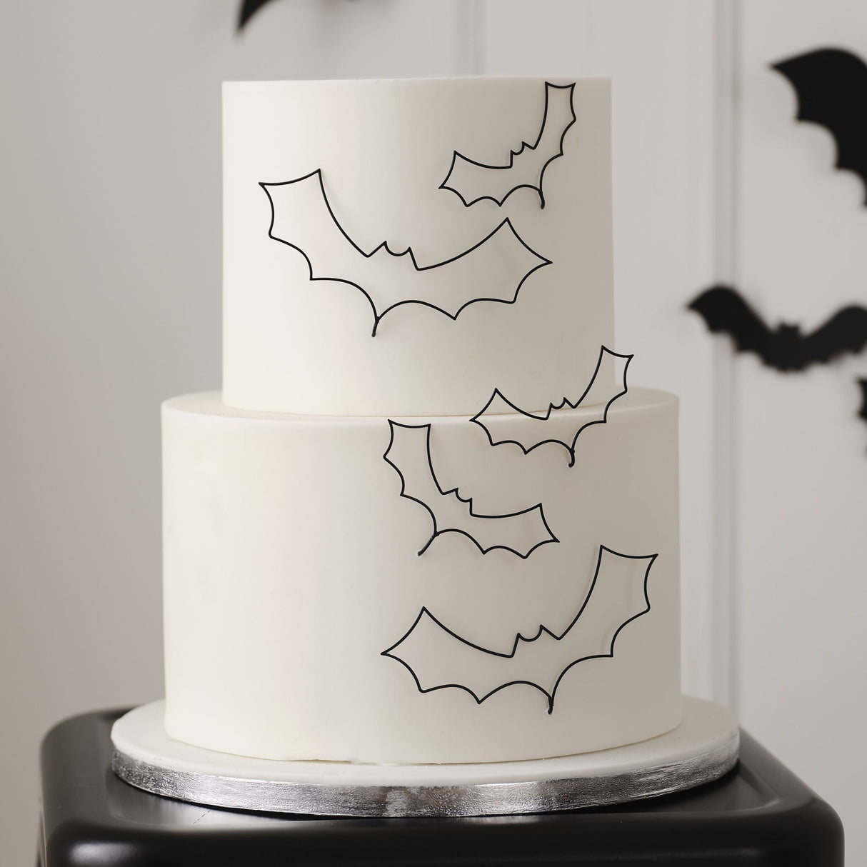 Spooky elegant black wire bat cake decorations for Halloween, featuring durable, reusable designs in eco-friendly packaging.